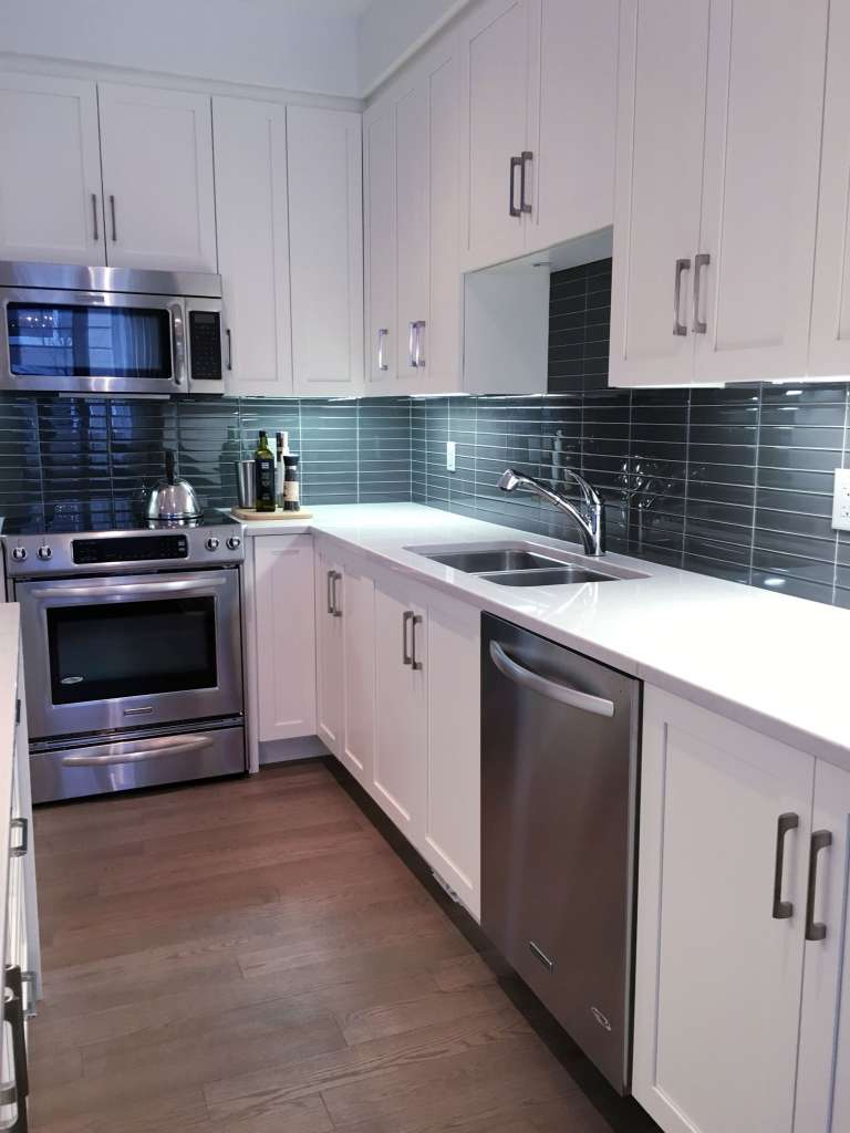 modern-kitchen-with-white-furniture-and-glass-tile-2022-11-15-20-54-05-utc