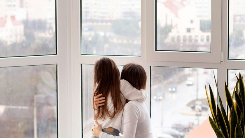 Mother and daughter looking outside of the uPVC Windows