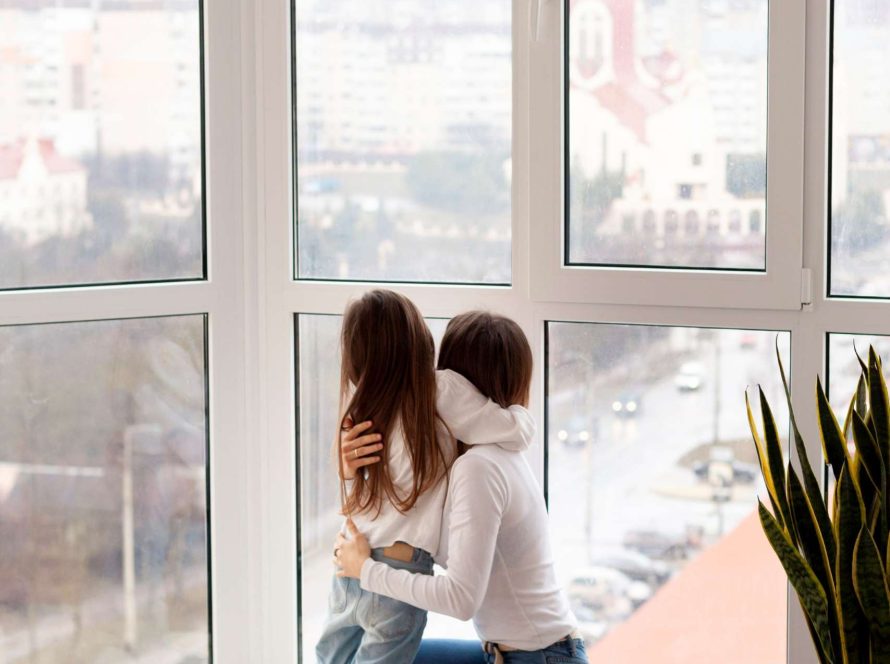 Mother and daughter looking outside of the uPVC Windows